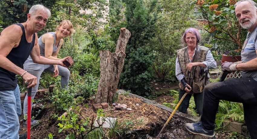 Garden Members posing around the common plot that was recently cleared out