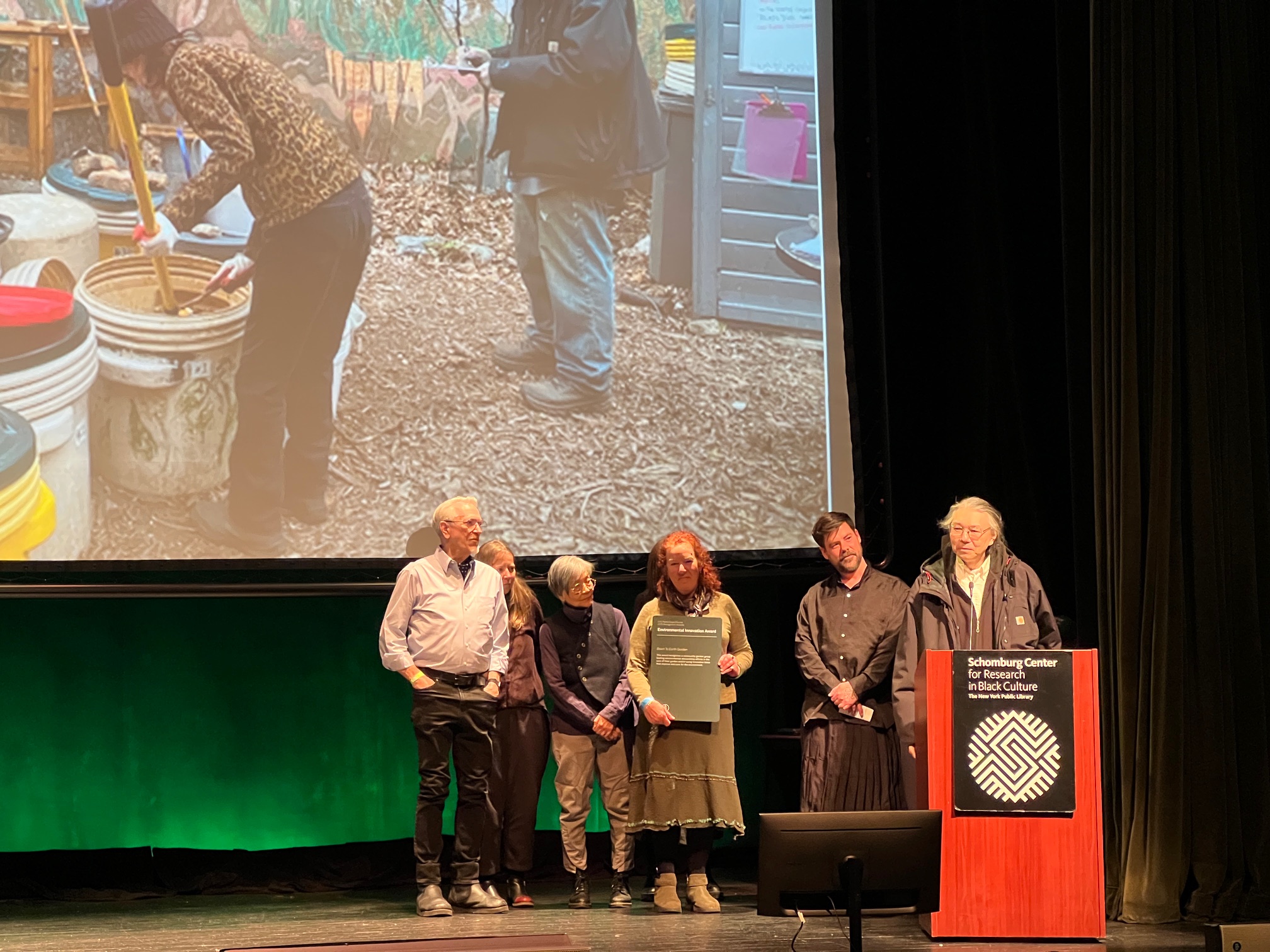 Shig Matsukawa and other gardeners on stage receiving the award.