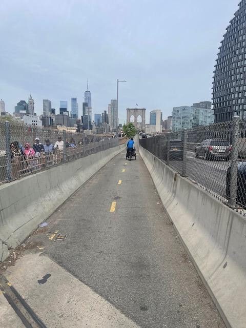 The beginning of the Brooklyn Bridge bike path - the tree is up ahead with the tower of the bridge and the Manhattan skyline in the background.